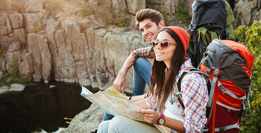 Intimate relationship couple hiking and looking at a map together